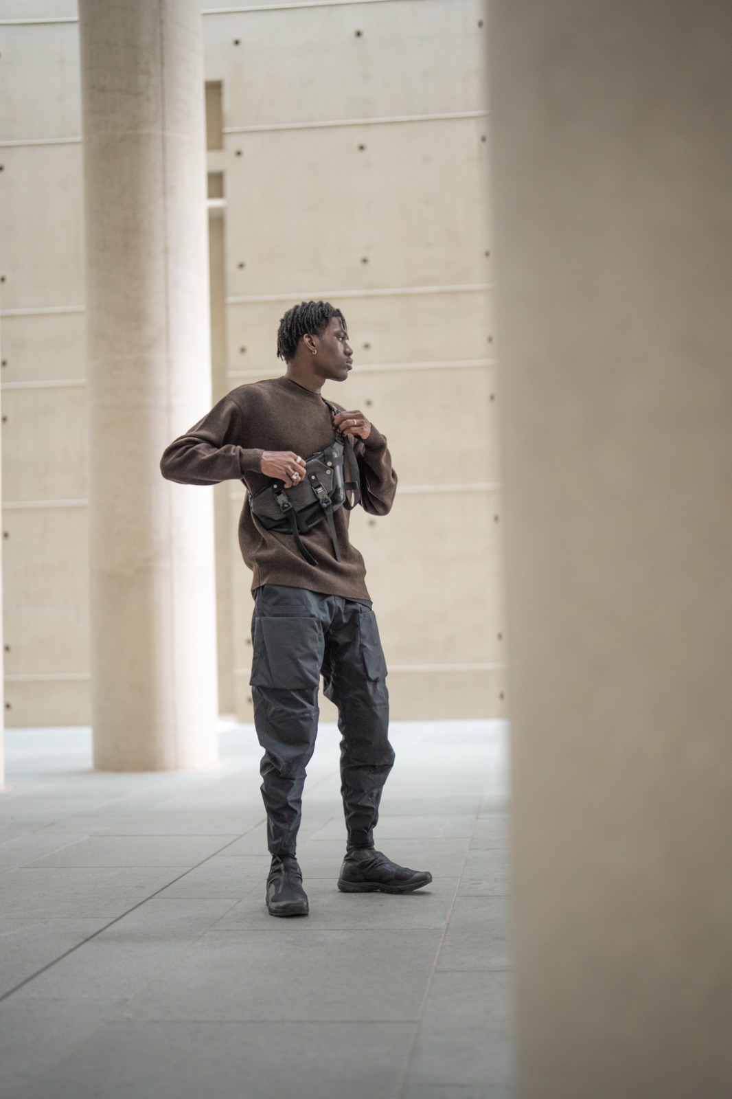 Enfin Levé yak wool sweater worn in a concrete setting, knitted in Mongolia by HYPECHASE