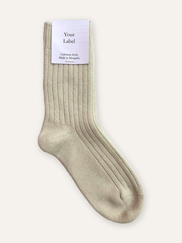 Ribbed 7 gauge cashmere sock in ivory with a Your Label paper tag